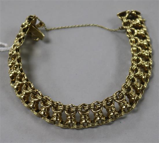 A 14ct gold fancy link bracelet, with safety chain.